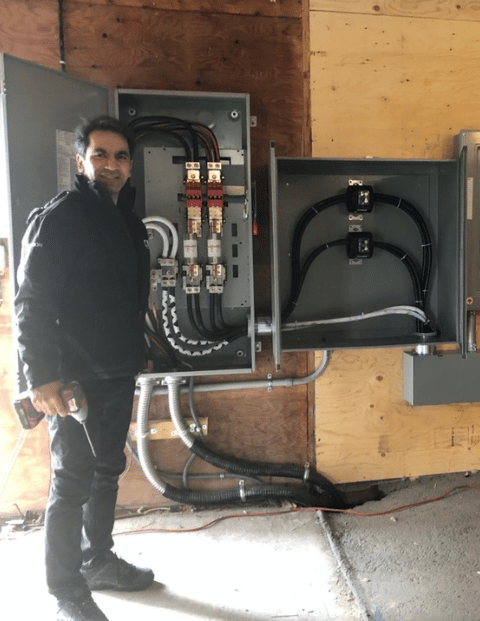 Electrician Farzad Nejatpour at work with commercial installation